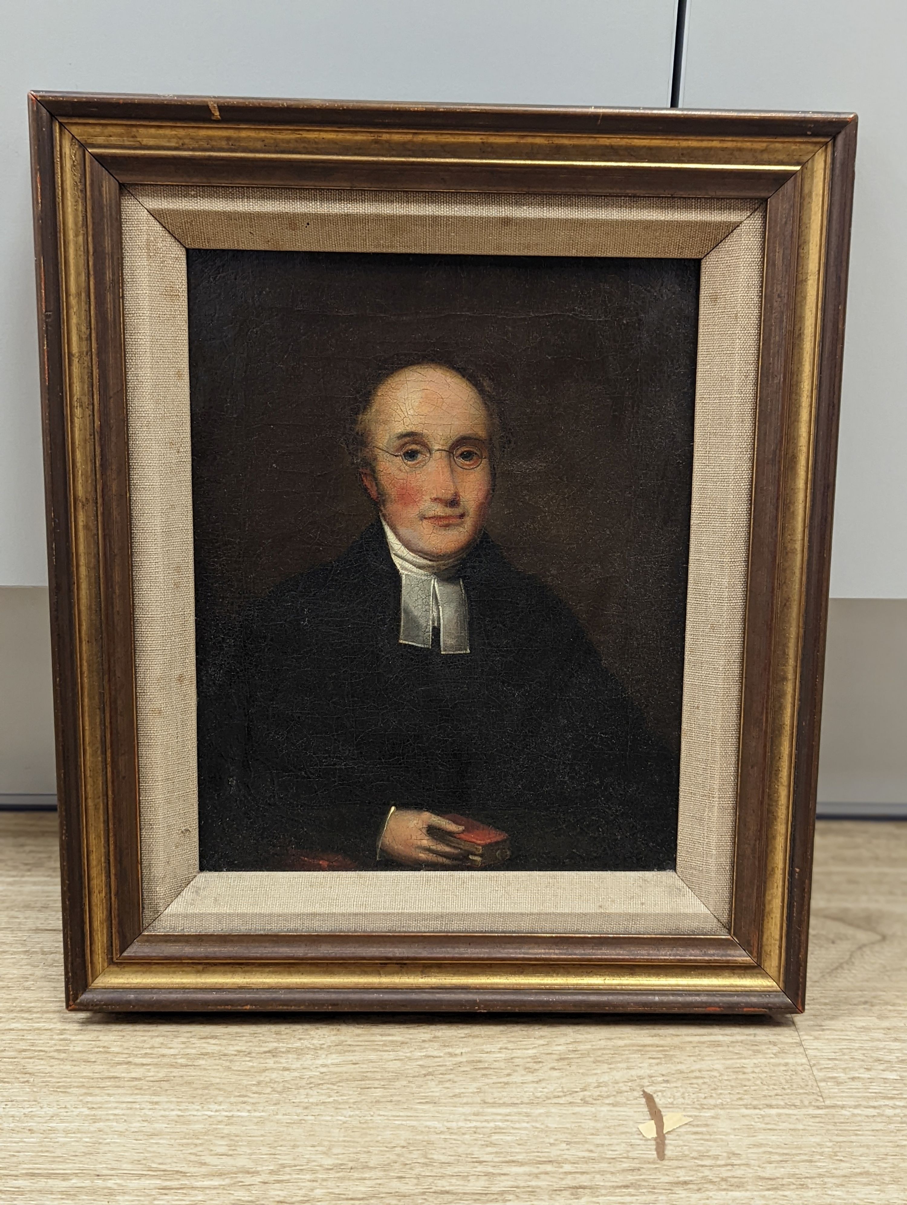 19th century Continental School, oil on canvas, portrait of a preacher holding a bible, 24 x 19cm